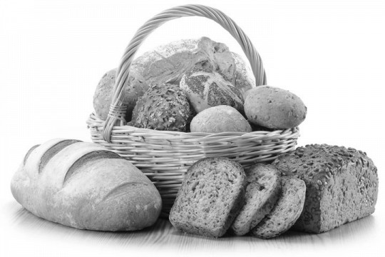 loaves of bread and rolls in a wicker basket